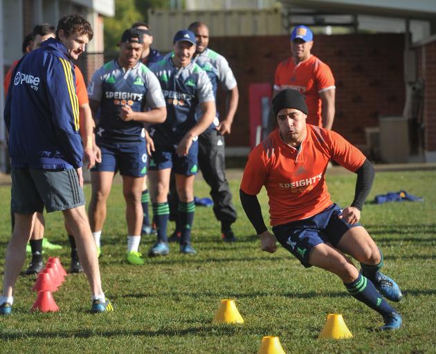 Highlanders and All Blacks halfback Aaron Smith dodges through some cones at training at Logan Park yesterday, watched by trainer Andrew Beardmore. Photo: Christine O'Connor
