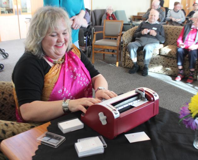 "That Blind Woman'' Julie Woods types a Holmdene resident's name in Braille as part of a new project to write one million names in the language used by the visually impaired. Photo: Samuel White