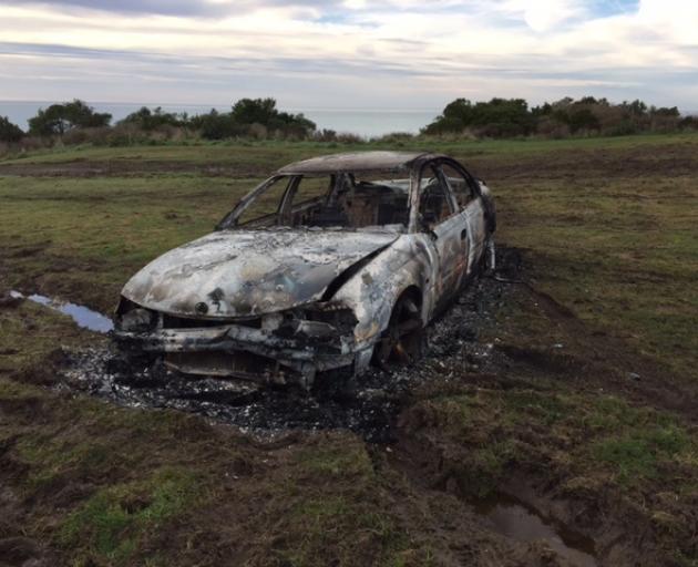 The remains of a white Holden VT Commodore which was found burnt near Wangaloa after it had been taken from a property in Kaitangata. Photo: NZ Police