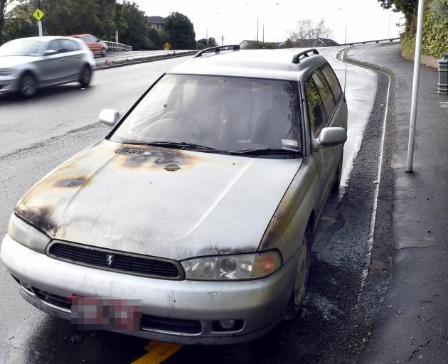 The burnt out vehicle on Stuart St this morning. Photo: Peter McIntosh