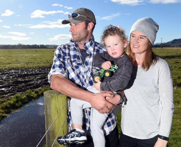 Henley dairy farmers Reon Hamilton and his fiance Emma Keene with son Cooper (2) at a flood recovery event at the Henley Community Centre yesterday. Photo: Gregor Richardson