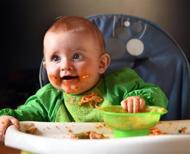 Eight month-old Hank Chapman makes a mess of his spaghetti and toast yesterday. PHOTO: STEPHEN...