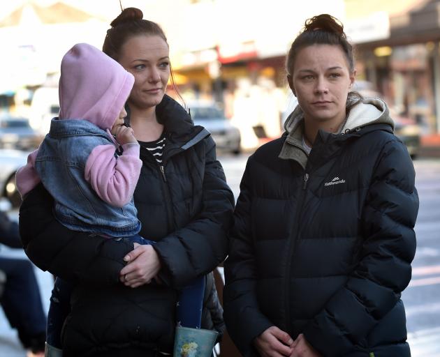 Amy Stuart, holding her daughter, and Kylie Taggart are at odds with the Ministry of Social Development about their situation. Photo: Peter McIntosh