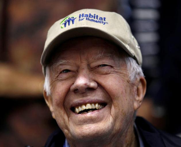 By Friday morning, former US President Jimmy Carter was smiling as he returned to the building site to help kick off the project's last day.