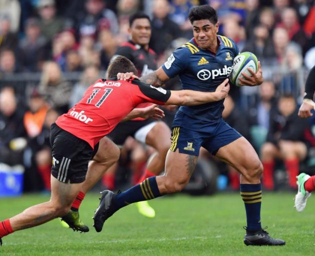 Highlanders centre Malakai Fekitoa tries to fend off Crusaders winger George Bridge last time the...