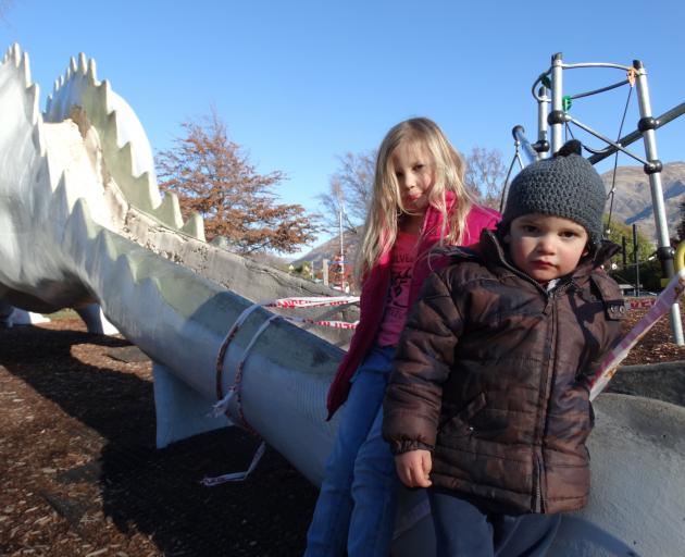 Damage to the fibreglass on Wanaka's famous dinosaur slide means it is off limits at the moment while it is repaired, leaving Lily (5) and Cooper (3) Edward, of Christchurch, a bit disappointed last week. Photo: Tim Miller