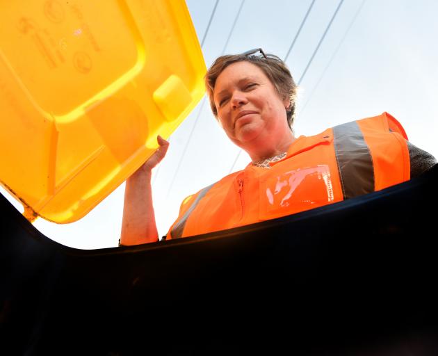 Dunedin City Council waste minimisation officer Cath Gledhill checks out a bin as part of a programme to make sure only correct recyclable items are put in them. Photo: Peter McIntosh