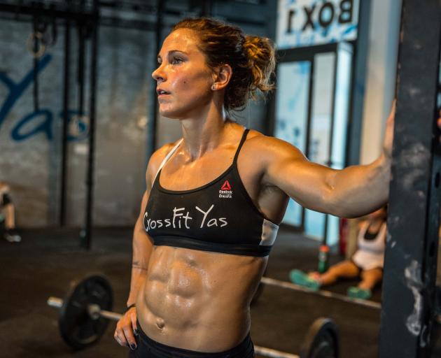 Crossfit competitor Jamie Greene takes a break during a workout at her gym in Abu Dhabi. PHOTO:...