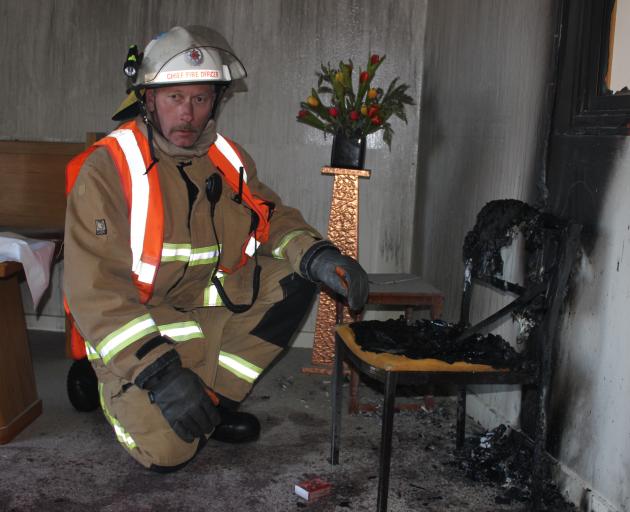 Alexandra Chief Fire Officer Russell Anderson inspects the scene of a suspected arson at Alexandra's St John The Baptist Catholic Church. Photo: Jono Edwards