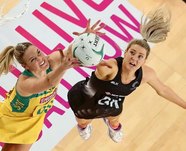 New Australian captain Caitlin Bassett (left) competes for the ball with Jane Watson during a...