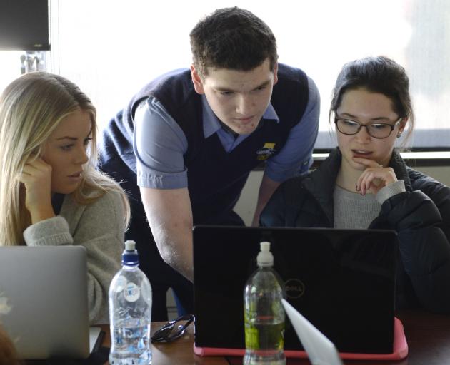 Taieri College pupil Trent Mitchell-Borley (14) shows University of Otago students Jeanie Pattison (21, left) and Jessie Cottrell (20) how to use the Scratch computer coding program. Photo: Gerard O'Brien