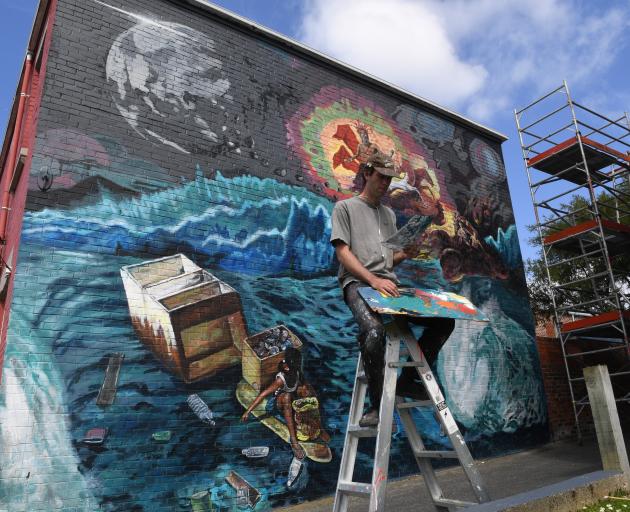 Guy Howard-Smith works on his street art mural in Castle St earlier this year. Photo: ODT.