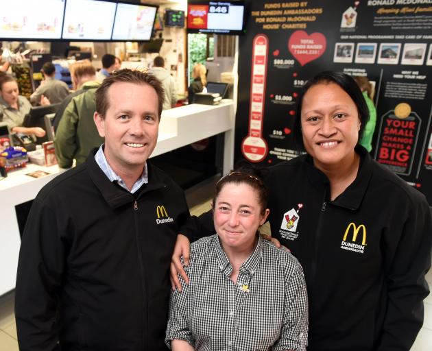 McDonald's owners Justin and Eterei Stonelake flank employee Natasha Watterston, one of more than 30 staff to have taken up their home deposit saving programme. Photo: Gregor Richardson