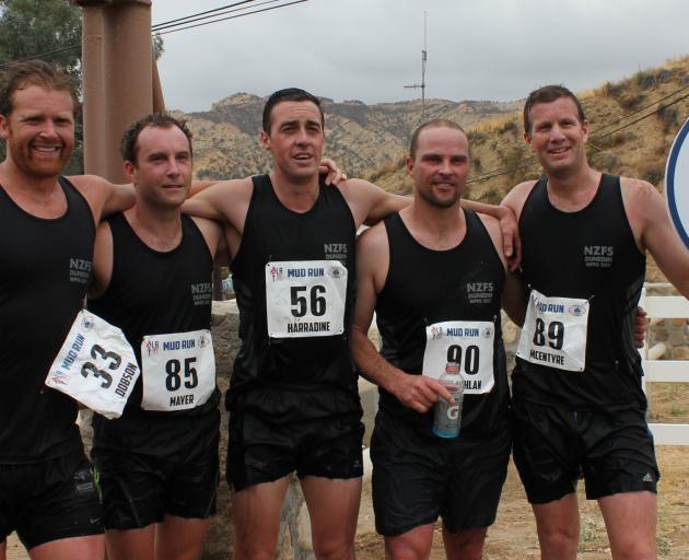 Dunedin firefighters (from left) Joe Dobson, Lee Mayer, Calvin Harradine, Cameron McLachlan and Tony McEntyre celebrate winning the ``mud run'' at the World Police and Fire Games in Los Angeles earlier this month. Photo: Supplied