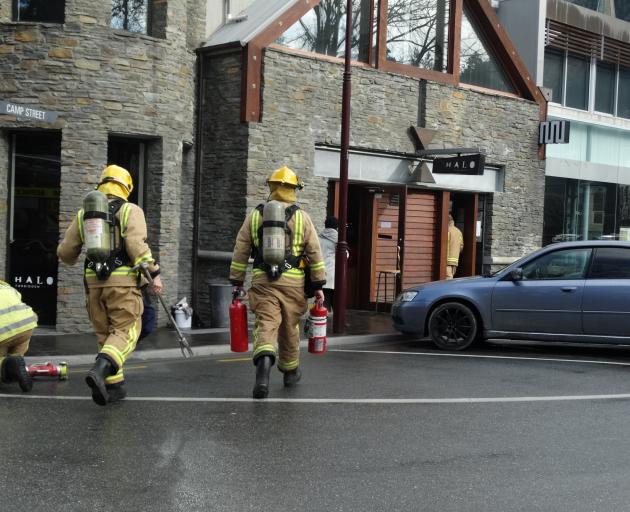 Queenstown fire volunteers approach Halo cafe in central Queenstown yesterday. Photo: David Williams