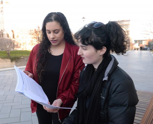 University of Otago students and members of the Students Against Sexual Violence at Otago group Monique Mulholland (left) and Kyra Gillies (both 21) read through a booklet on Monday which discusses sexual violence at the University of Otago campus. Photo: