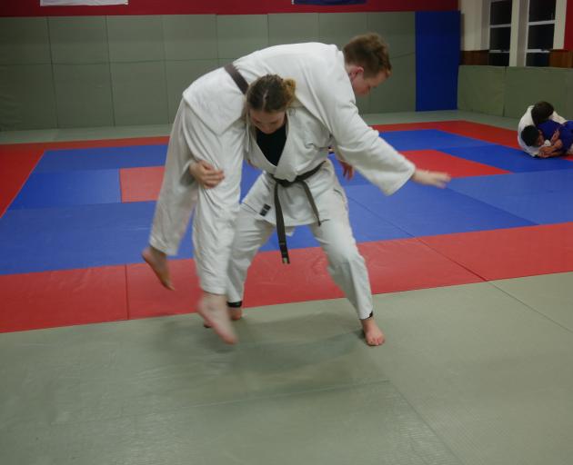 Renshuden Judo Club member Alaina Baker performs a kataguruma, or shoulder wheel, on fellow club member Dylan Murcott. PHOTO: JESSICA WILSON