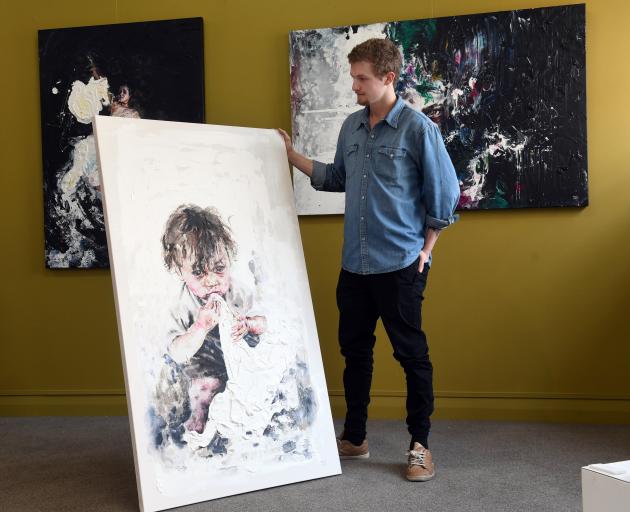 Tyler Kennedy Stent with a painting of one of the younger member’s of Mai-Lee’s family. Photo: Stephen Jaquiery