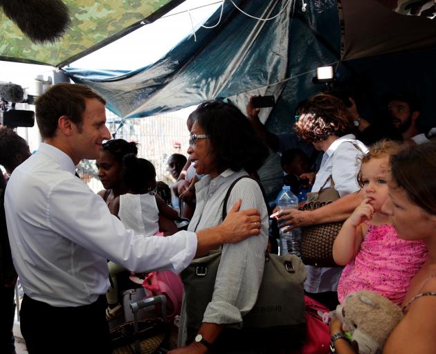 President Emmanuel Macron comforts residents during his visit to the French Caribbean island of St Martin. Photo: Reuters