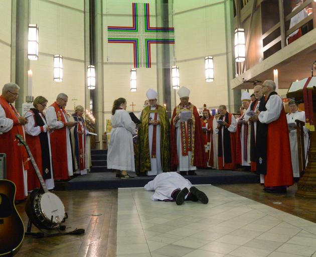 Dr  Benford prostrates in silence in front of the altar during his installation as Anglican...