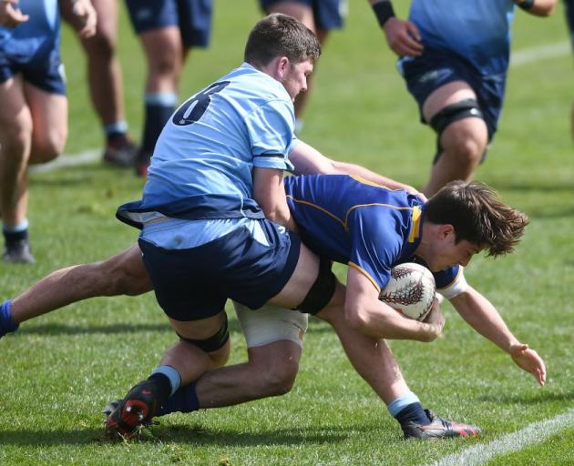Otago first five-eighth George Witana fights through a tackle to score one of eight Otago tries....