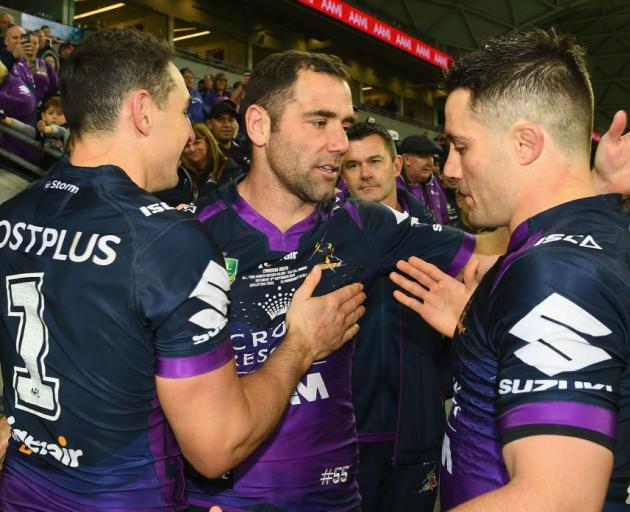 Billy Slater, Cameron Smith and Cooper Cronk celebrate their qualifying final win over the...