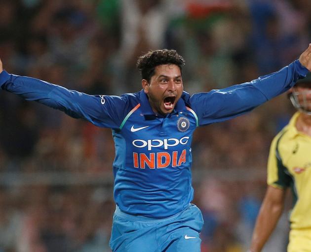 India's Kuldeep Yadav celebrates his hat-trick against Australia after dismissing Pat Cummins....