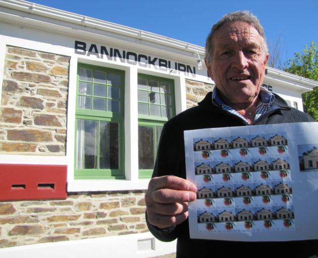 Bannockburn volunteer Edgar Parcell shows off the commemorative Bannockburn stamp at a special...
