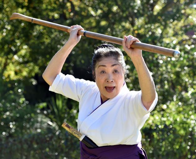 Japanese martial arts teacher Shimizu Nobuko Sensei (75) prepares to strike with her naginata at...