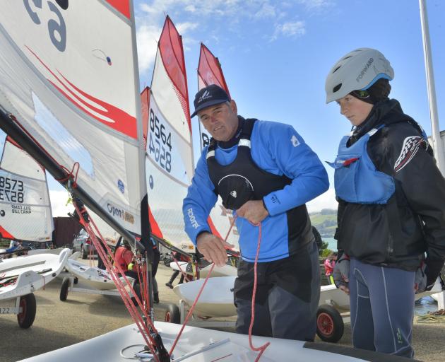 Sir Russell Coutts shows Oamaru sailor Will Plunket the ropes on his O'pen BIC craft sailboat at the Ravensbourne Yatch Club yesterday. Photo: Gerard O'Brien