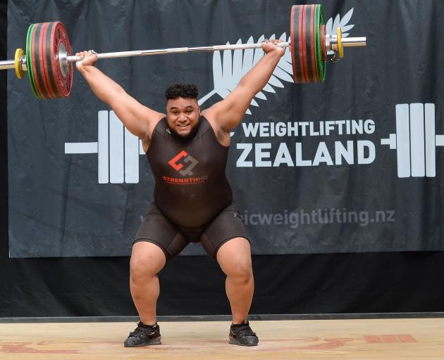 David Liti (21) snatches 153kg on the way to securing his third national Olympic weightlifting...