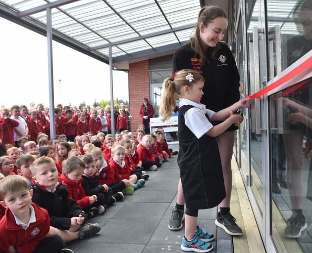 One of Fairfield School oldest pupils, Mikayla Preston and the school's youngest, Calla Weir, cut...