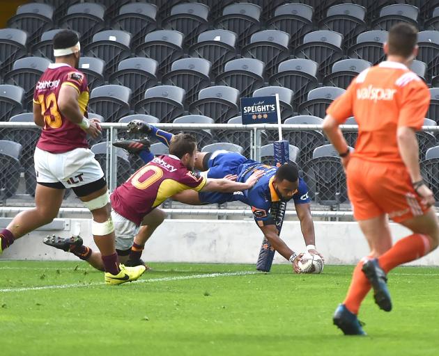 Otago winger Jona Nareki scores in the corner despite the efforts of Southland first five-eighth...