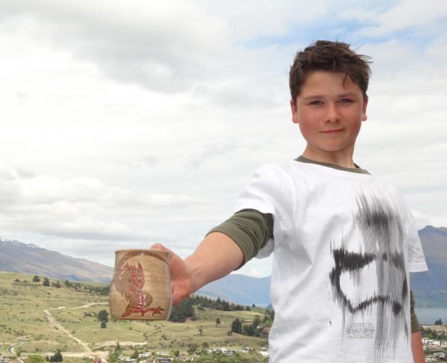 Queenstown youngster Peter Bodie-Healy shows the flagon he designed with Weta Workshop staff...