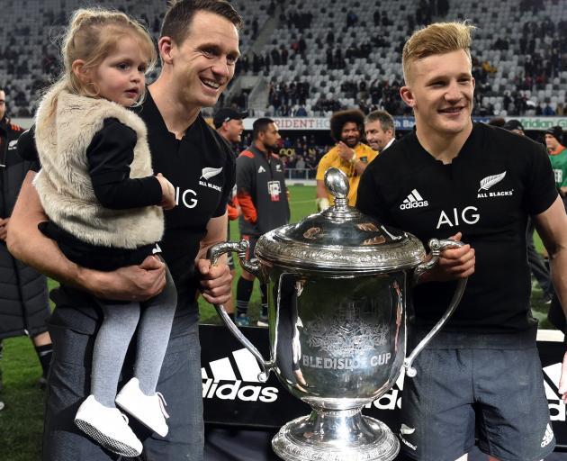 Who's better? Ben Smith and his daughter Annabelle with the Bledisloe Cup and All Black Damian...