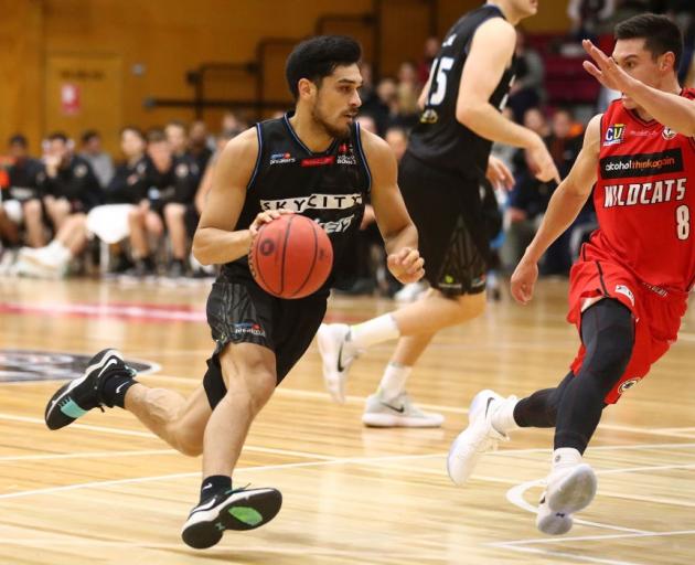 Breakers point guard Shea Ili dribbles at Perth Wildcats guard Jarrod Kenny at the NBL preseason...