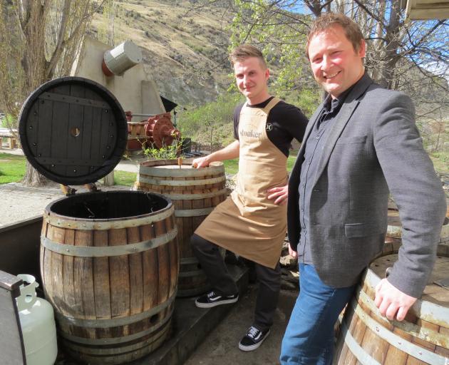 Wild Earth Wines' 2014 and 2015 pinot noirs have done well in competition this year. Their biggest market is visitors to the cellar door at Kawarau Gorge. Head chef George Sumara (left) and marketing manager Elbert Jolink, pictured by wine barrels that ha