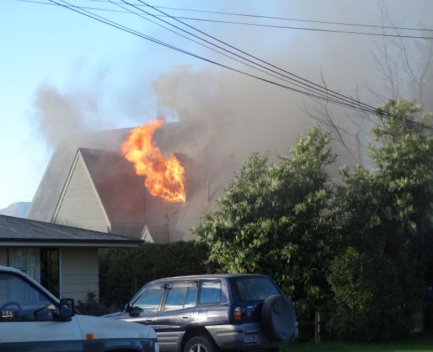 A chimney fire roared out of control in Wanaka last night, fully involving the house. Photo: Kerrie Waterworth A chimney fire roared out of control in Wanaka last night, fully involving the house. Photo: Kerrie Waterworth