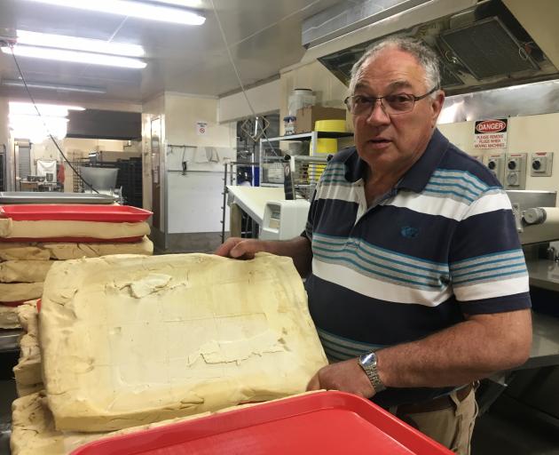 Jimmy’s Pies owner Dennis Kirkpatrick inspects the pie trim which is used to make bases, in...