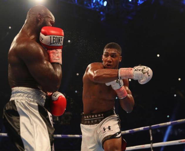 Anthony Joshua throws a right-hand punch in his recent fight against Carlos Takam. Photo: Getty...