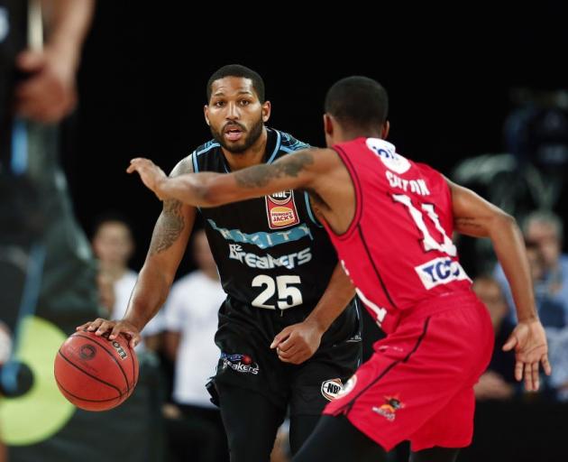 New Zealand Breakers guard DJ Newbill handles the ball while being guarded by Perth Wildcats...
