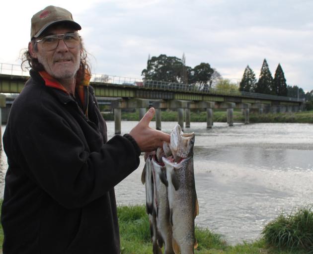 Bill Coughlan, of Gore, displays his opening day bag on the Mataura River in October 2015. He caught four nice trout on the river north of Gore. Photo: Margaret Phillips