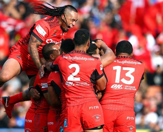 Tonga celebrate during the 2017 Rugby League World Cup match between the New Zealand Kiwis and...