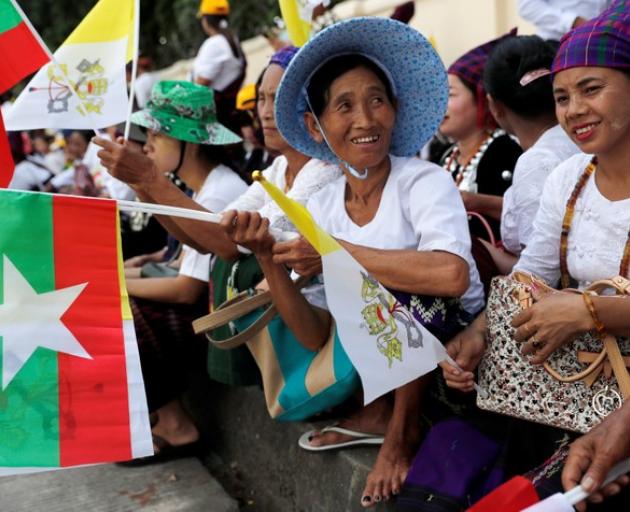 People gather outside the the residence of Cardinal Charles Maung Bo, Archbishop of Yangon, where Pope Francis will be staying during his visit in Yangon. Photo: Reuters