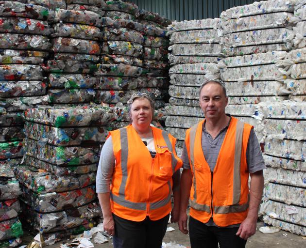 Catherine Gledhill and Jeff Gamble at the recycling plant in Green Island, with baled plastics processed to be recycled and re-used. PHOTO: ELLA STOKES