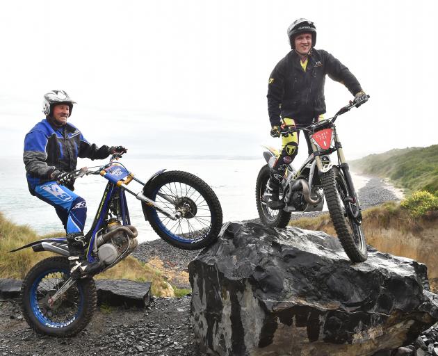 Gavin (left) and Blake Fox ride over an obstacle on their trials bikes at Blackhead yesterday...