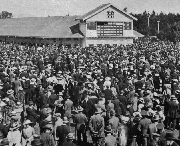 The crowd in front of the totalisator at the New Zealand Metropolitan Trotting Club's spring...