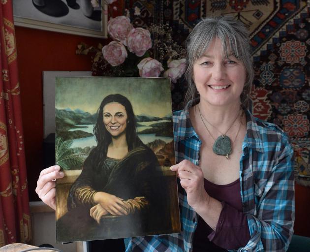 Victoria Heatherbell holds an image of her painting of Prime Minister Jacinda Ardern in the style...