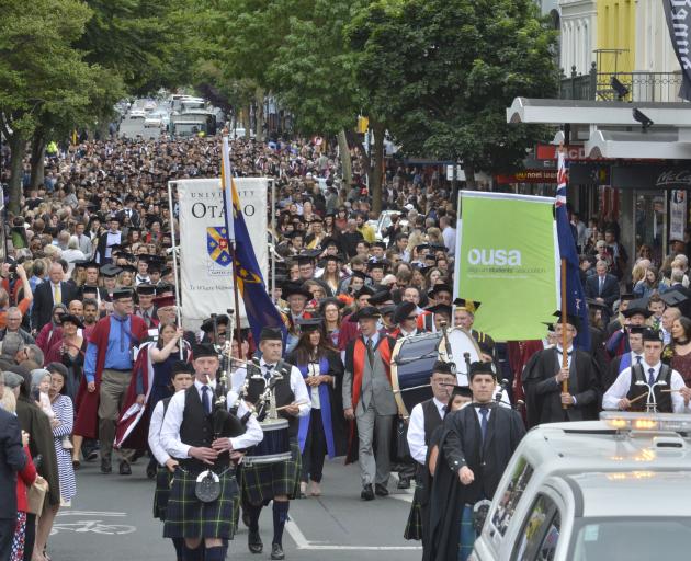 University of Otago graduands are joined by family and friends as they take over George St, marching to the Dunedin Town Hall for a graduation ceremony on Wednesday. Photo: Gerard O'Brien