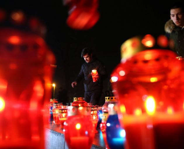 Bosnian Croats light candles for convicted general Slobodan Praljak, who killed himself seconds after the verdict in the United Nations war crimes tribunal in The Hague, in Mostar, Bosnia in November. Photo: Reuters